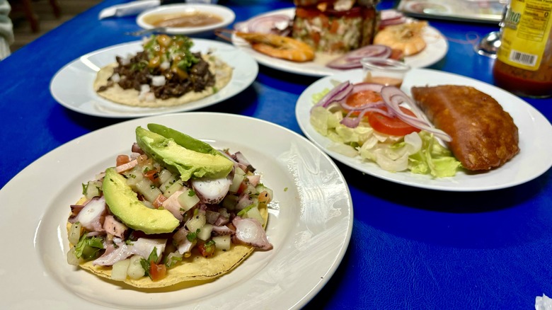 plates of seafood on blue table