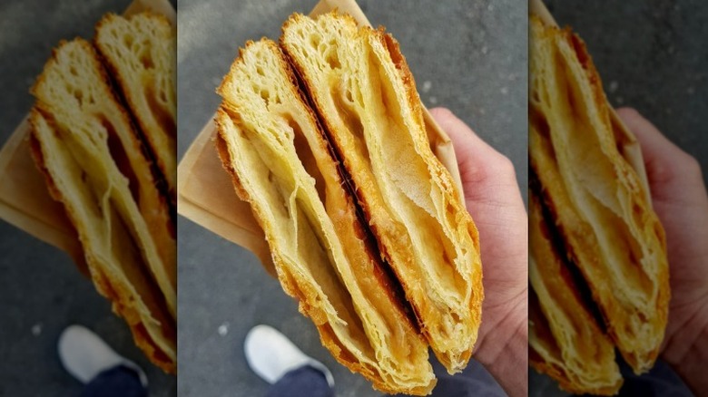 hands holding apricot filled pastry