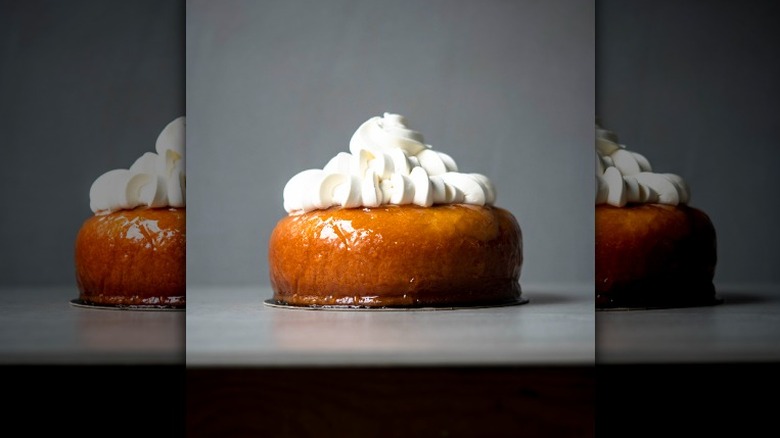 baba au rhum topped with cream