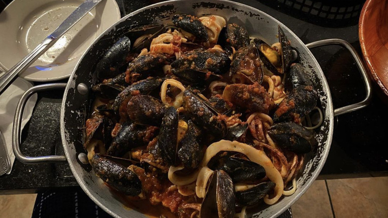 Pasta with seafood in metal pot