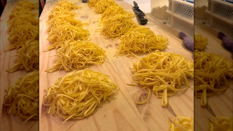 piles of homemade fettucine on table