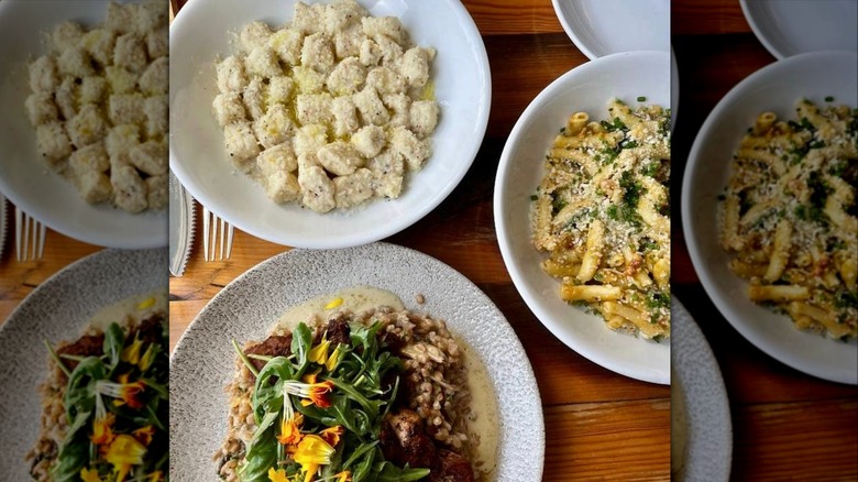 Plates of various pasta dishes on dinner table