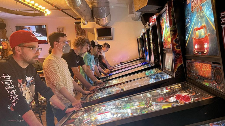 people playing pinball