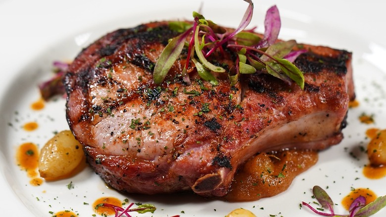 Kurobata pork chop plated with micro greens