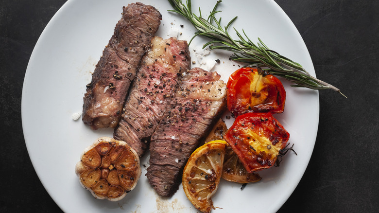 Grilled wagyu steak with garlic, rosemary, and tomatoes