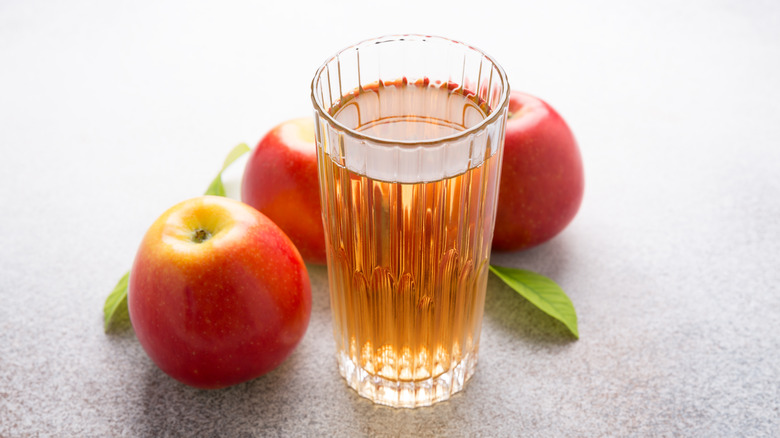 Apple juice in glass, apples