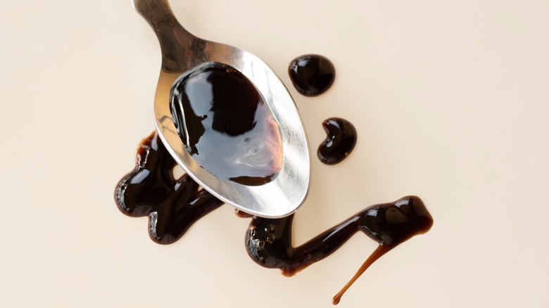 Spoon drizzling balsamic vinegar