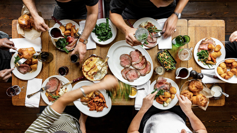 friends around table eating roast