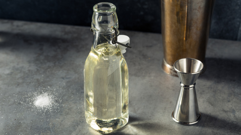 Open bottle of simple syrup on a marble surface