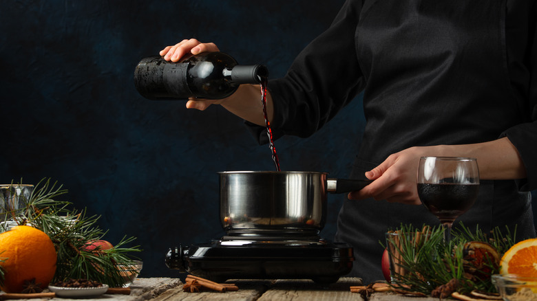 Pouring red wine into pan