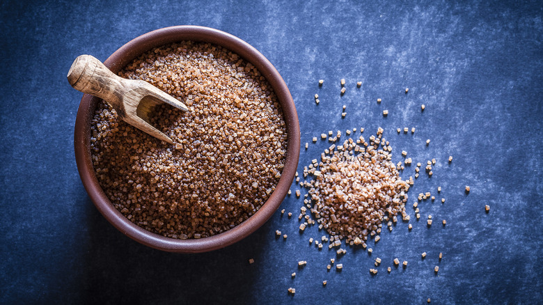 Organic brown sugar on blue background