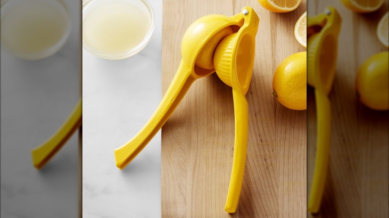 Lemon press on wooden counter with juice