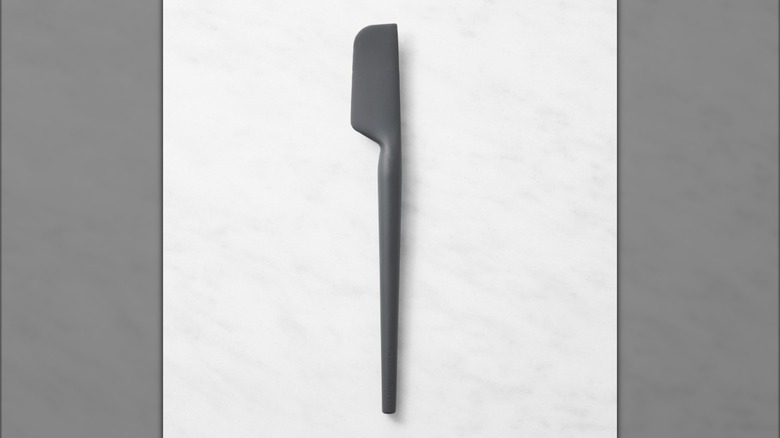 Flexible jar scraper on marble surface