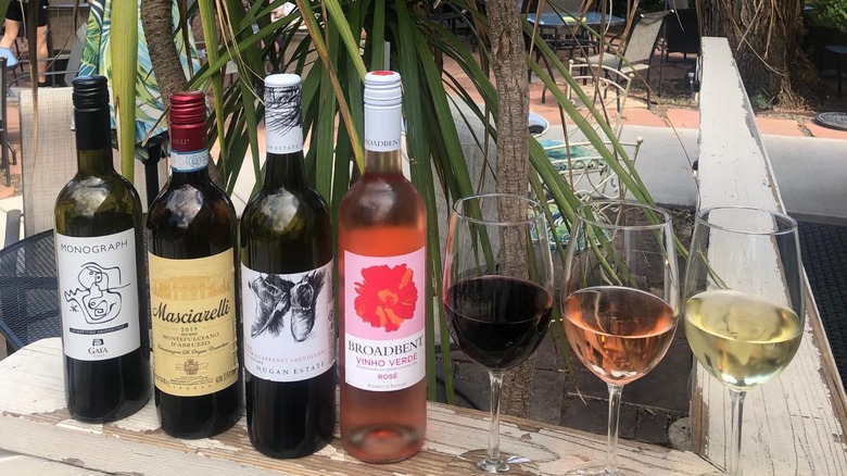 Red and rose wine bottles next to poured glasses of wine at Flights Wine Cafe