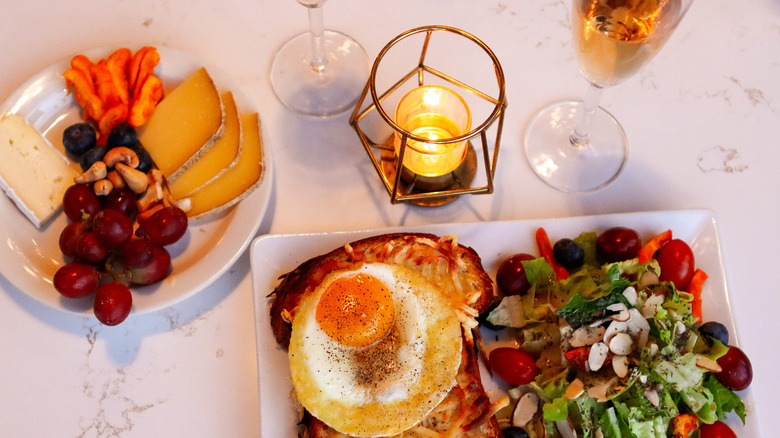 Cheese plate and open faced sandwich near a candle at La Bouche