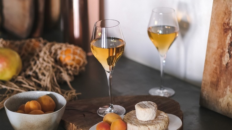 Glasses of orange wine and cheese