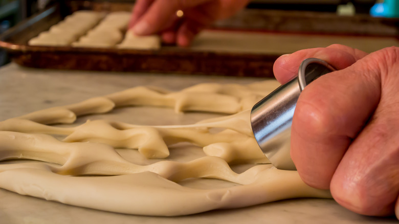 Person cutting biscuit dough