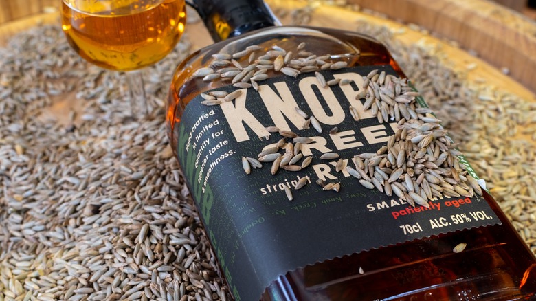 Bottle of Knob Creek Rye with rye grains