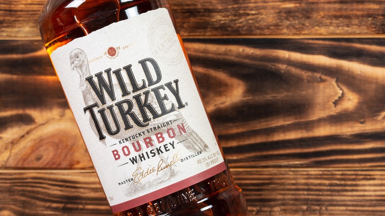 Bottle of Wild Turkey on a wooden background