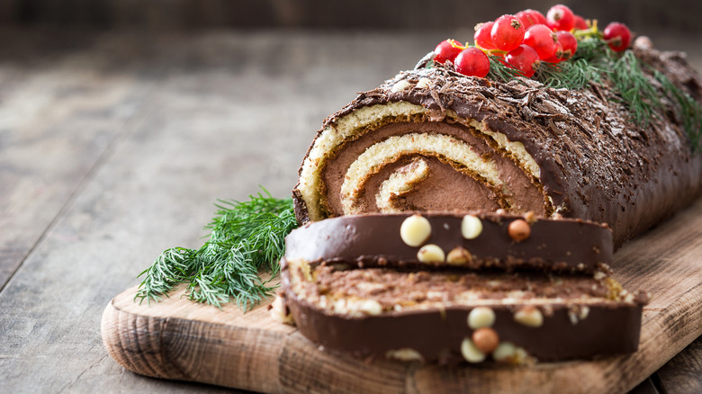 sliced chocolate cake on wooden plank