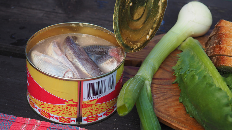 Canned herring on table