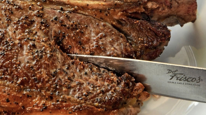 Cutting into seasoned steak