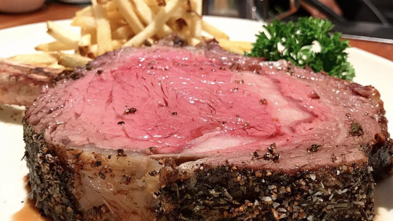 cut of steak with fries