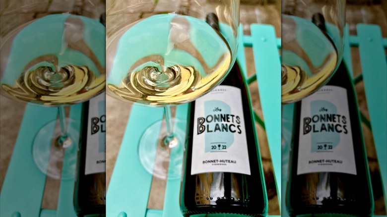 glass of white wine with close up of bottle label