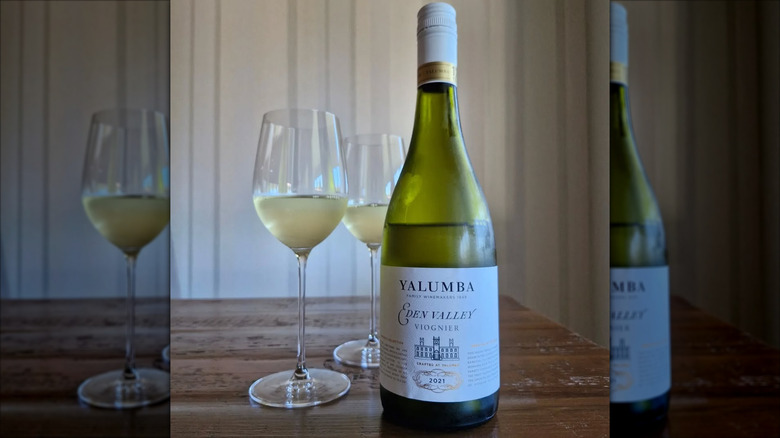 bottle of white wine with two glasses