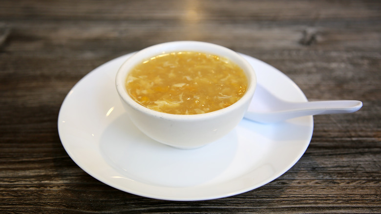 Small bowl of egg drop soup with a spoon