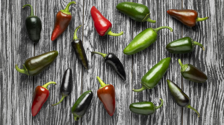 different colored hot jalapeños peppers on the table