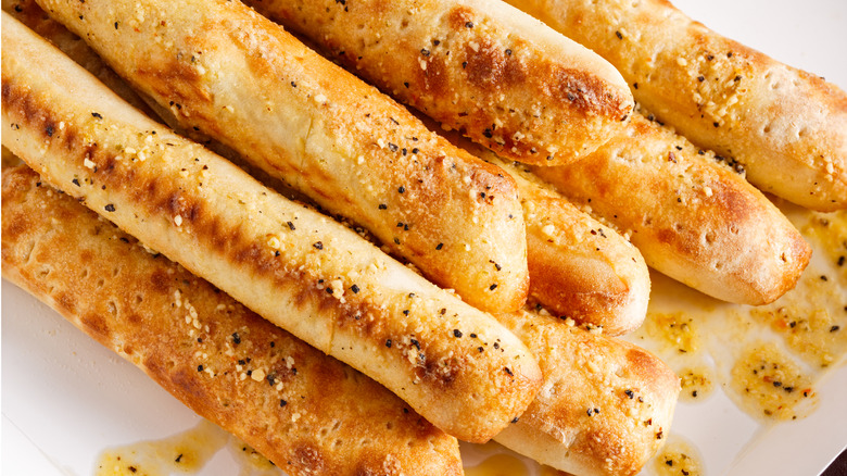 pile of bread sticks seasoned with butter and herbs