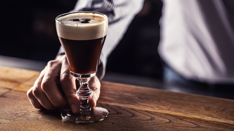 Bartender passing a coffee cocktail