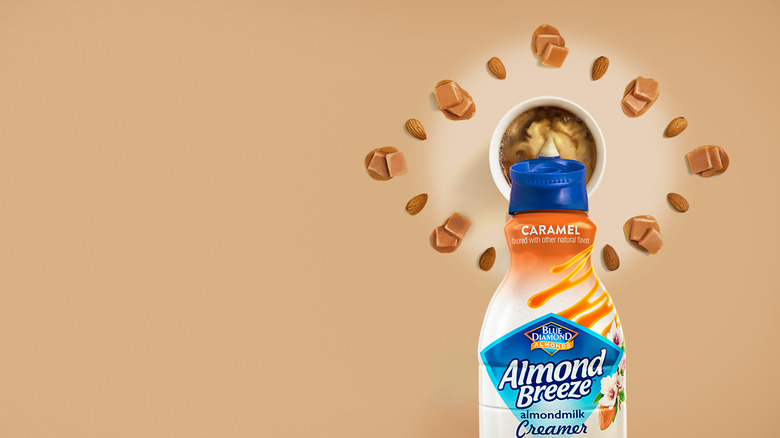 Creamer bottle surrounded by almonds