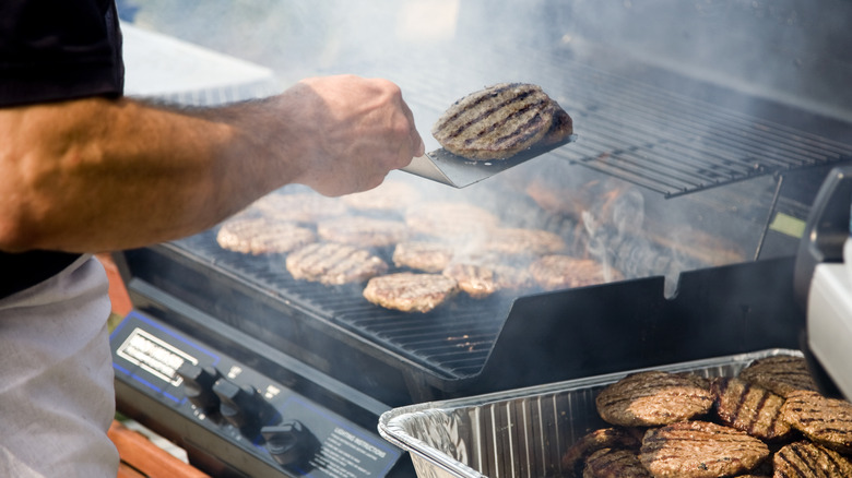 Flipping burger on a hot grill