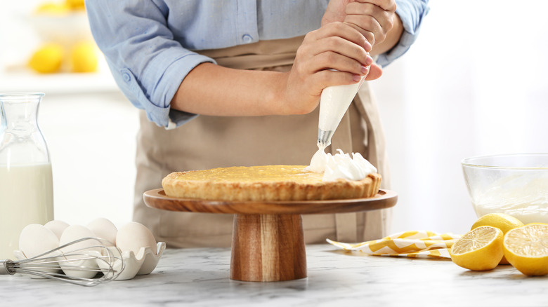 Piping meringues onto pie