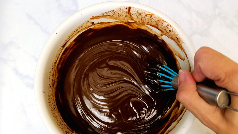 whisking ganache in a white bowl