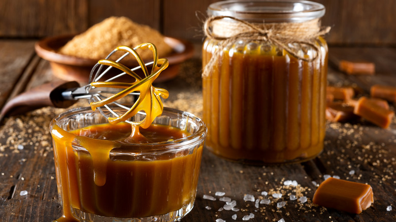 jars of caramel sauce on wooden table