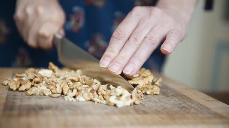 Chopped walnuts on board