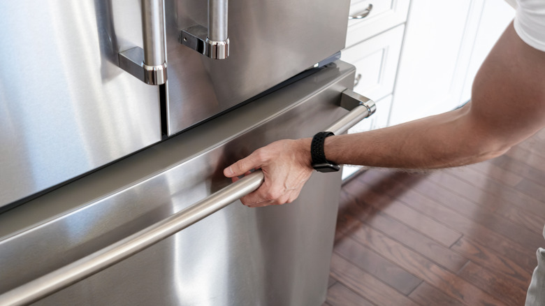 Freezer with hand on handle