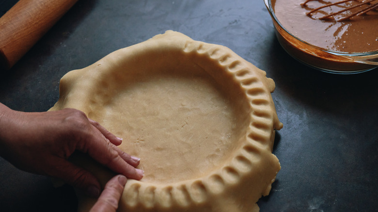 Person prepping pie crust
