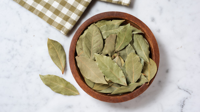 Wooden bowl filled with dried bay leaves