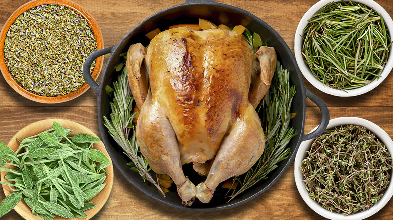 Roast turkey surrounded by various bowls of herbs