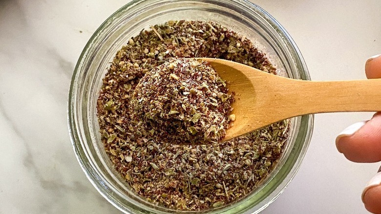 Za'atar spooned out of glass jar