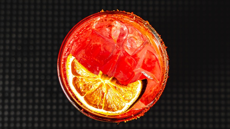 Exquisite fresh and spicy cocktail with vibrant colors and a touch of spice on dark background