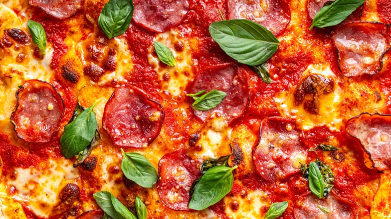 Close-up of pepperoni pizza with basil