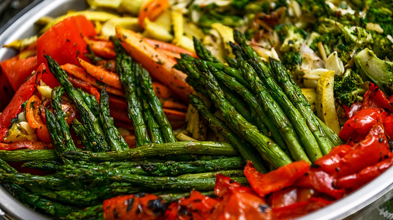 Assorted sauteed vegetables, including asparagus, carrots, squash, broccoli and red peppers