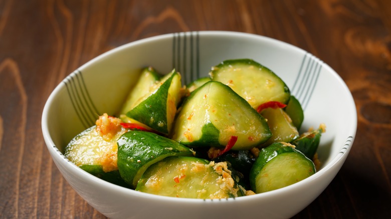 Spicy pickles in jar with spices