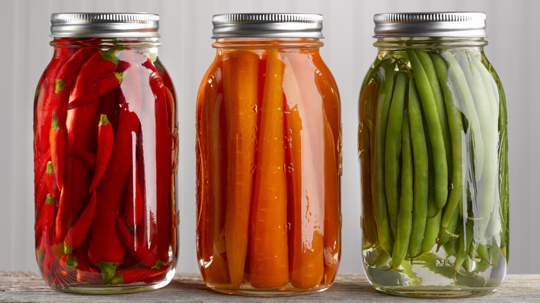 Jars of pickled peppers, carrots, and green beans