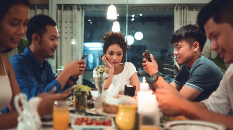 People on phones during dinner